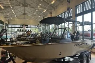 Slide: The Image of 2026 Tracker Targa V-18 Combo boat displayed in a showroom. - 3
