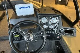 Slide: The Image of 2026 Tracker Targa V-18 Combo dashboard with steering wheel and Lowrance display. - 6