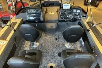 Slide: The Image of 2026 Tracker Targa V-18 Combo boat interior with four seats and modern dashboard. - 5