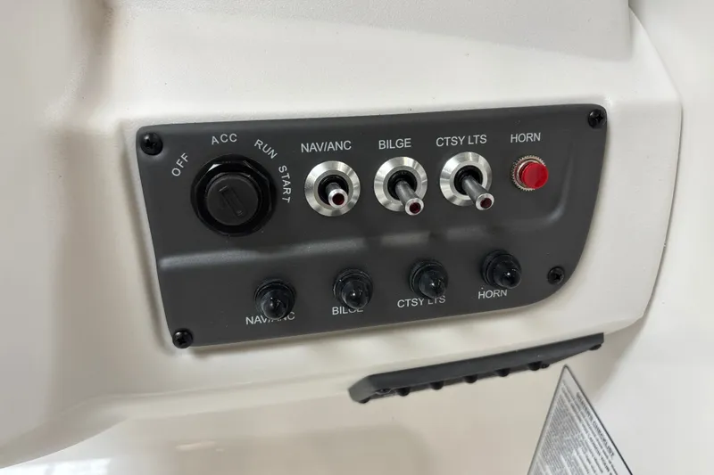Slide: The Image of Control panel of a 2026 Tahoe T18 boat with switches and ignition. - 15