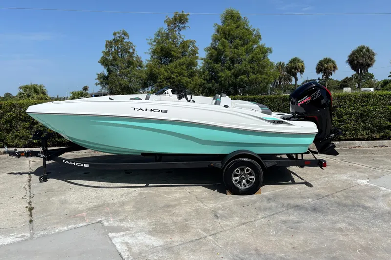The Image of 2026 Tahoe T18 boat on trailer, mint green hull, parked outdoors. - 0