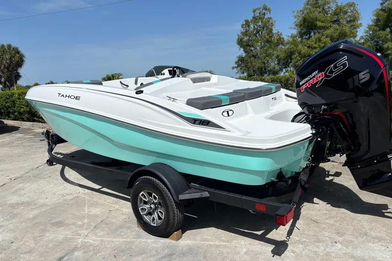 Slide: The Image of 2026 Tahoe T18 boat with Mercury Pro XS 115 engine on trailer, parked outdoors. - 3