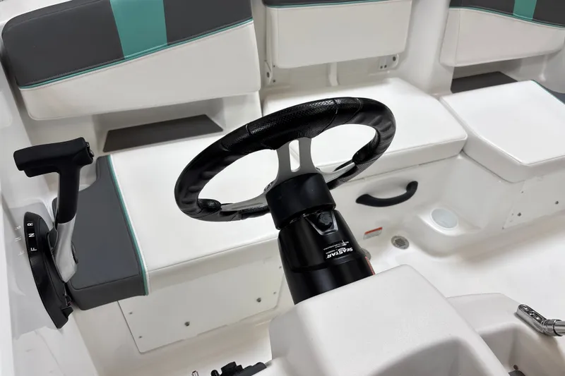Slide: The Image of Interior of 2026 Tahoe T18 boat featuring steering wheel and seating area. - 13