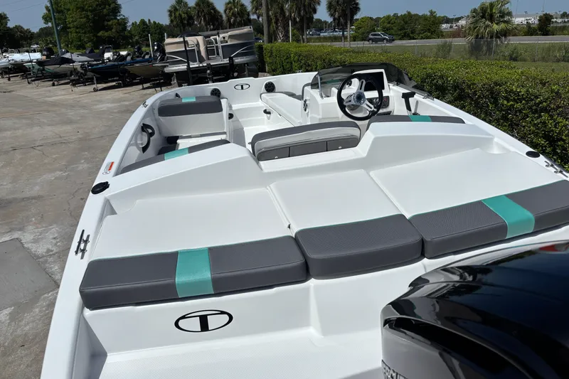 Slide: The Image of 2026 Tahoe T18 boat with sleek seating and modern design in a marina setting. - 8