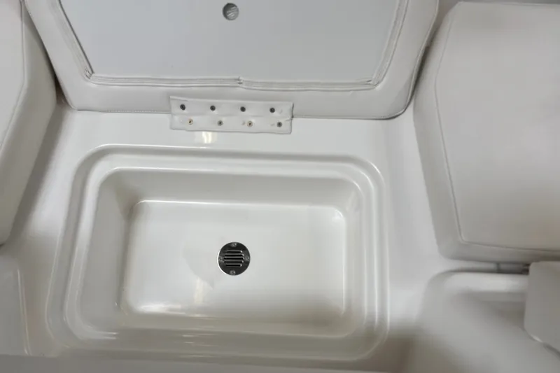 Slide: The Image of 2026 Tahoe T18 boat interior storage compartment with drain. - 24