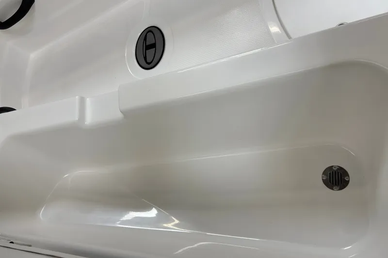 Slide: The Image of Close-up of a white boat deck with a drain and circular details. - 23