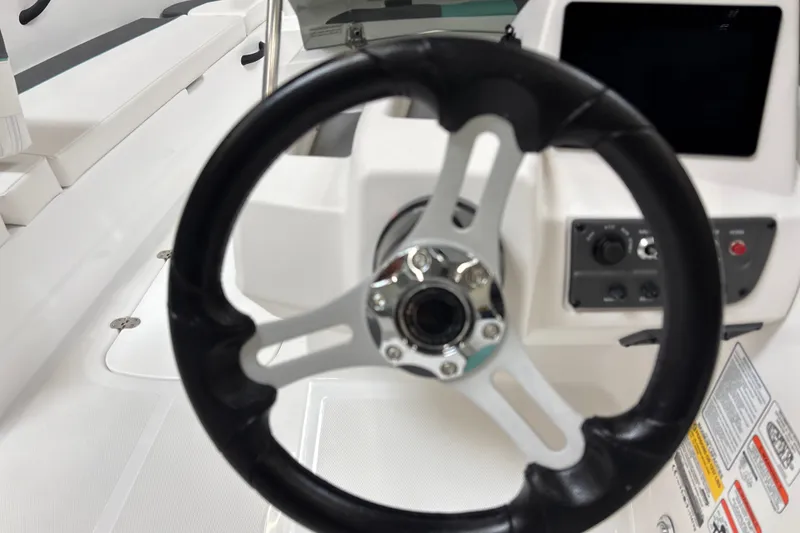 Slide: The Image of Steering wheel of 2026 Tahoe T18 boat with control panel and seating. - 14