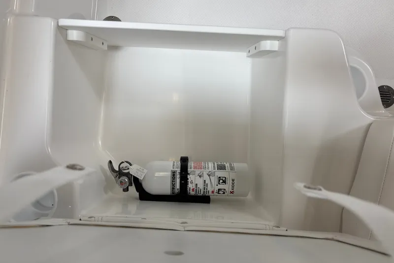 Slide: The Image of Fire extinguisher in 2026 Tahoe T18 boat compartment, securely mounted for safety. - 19