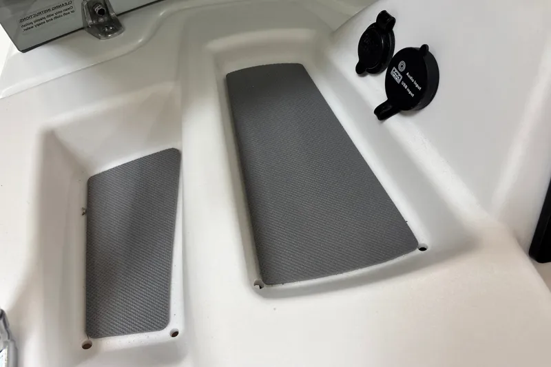 Slide: The Image of Interior view of 2026 Tahoe T18 boat with gray padded surfaces and audio input. - 17