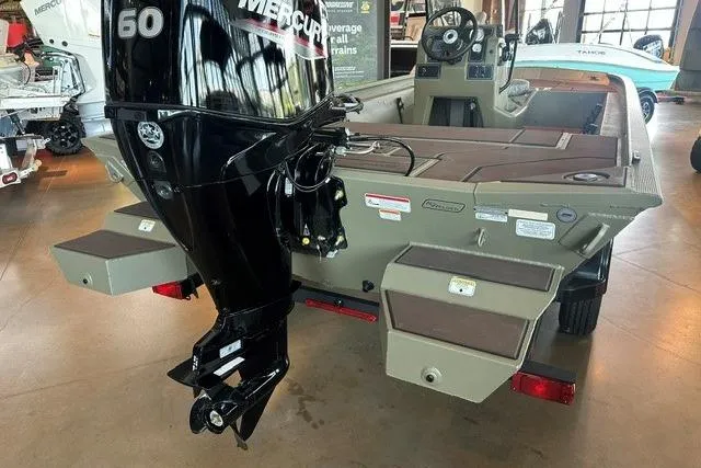 Slide: The Image of 2026 Tracker Grizzly 1860 CC boat with Mercury outboard motor in showroom. - 11
