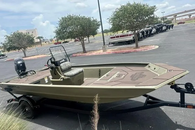Slide: The Image of 2026 Tracker Grizzly 1860 CC boat in parking lot, featuring a sleek design and spacious deck. - 5