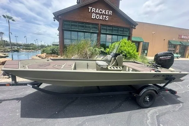 Slide: The Image of 2026 Tracker Grizzly 1860 CC boat on trailer outside Tracker Boats store. - 3