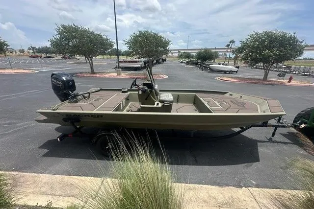 Slide: The Image of 2026 Tracker Grizzly 1860 CC boat in parking lot, side view, under cloudy sky. - 4