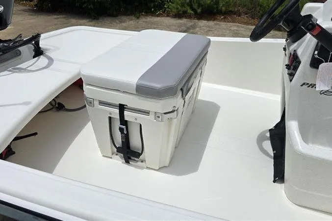 Slide: The Image of 2026 Mako Pro Skiff 15 CC interior with cushioned cooler seat. - 11