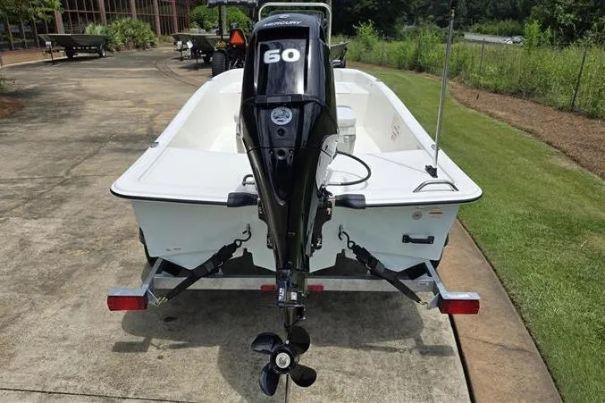 Slide: The Image of 2026 Mako Pro Skiff 15 CC boat on trailer, featuring a 60 HP outboard motor. - 4