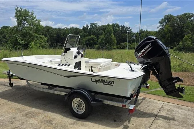 Slide: The Image of 2026 Mako Pro Skiff 15 CC boat with Mercury engine on trailer, outdoors. - 5
