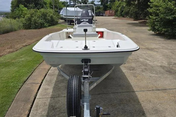 Slide: The Image of 2026 Mako Pro Skiff 15 CC on trailer, parked on a driveway, surrounded by greenery. - 8