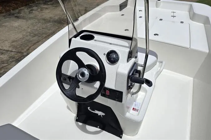 Slide: The Image of 2026 Mako Pro Skiff 15 CC boat console with steering wheel and controls. - 12