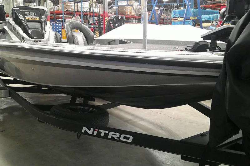 Slide: The Image of 2024 Nitro Z21 XL boat on trailer in warehouse setting. - 1