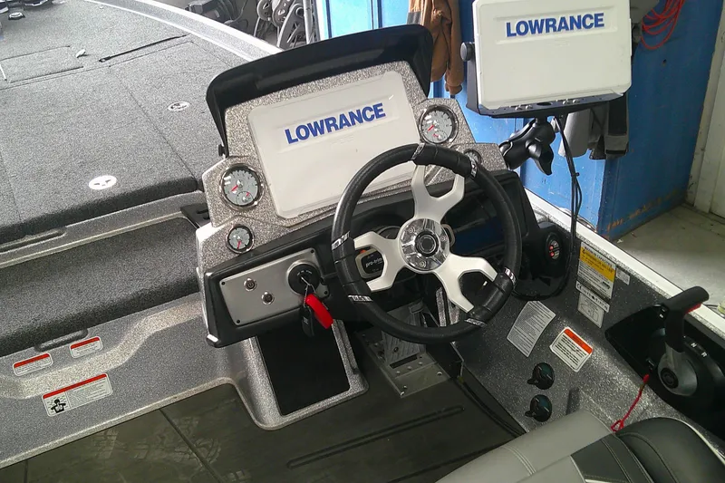 Slide: The Image of 2024 Nitro Z21 XL boat dashboard with Lowrance electronics and steering wheel. - 10