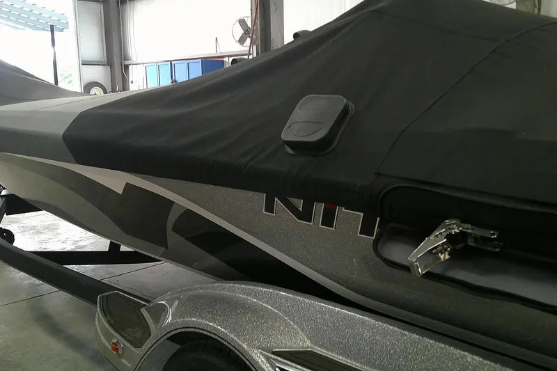 Slide: The Image of 2024 Nitro Z21 XL boat with protective cover in a garage setting. - 5