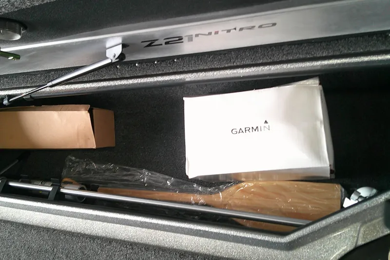 Slide: The Image of Storage compartment of 2024 Nitro Z21 XL boat with Garmin box and equipment. - 7