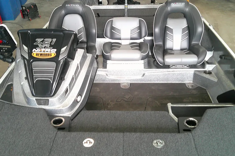 Slide: The Image of 2024 Nitro Z21 XL boat interior with three seats and branded engine cover. - 9