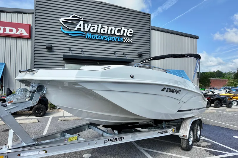 Slide: The Image of 2026 Starcraft SVX 211 OB boat on trailer at Avalanche Motorsports dealership. - 1