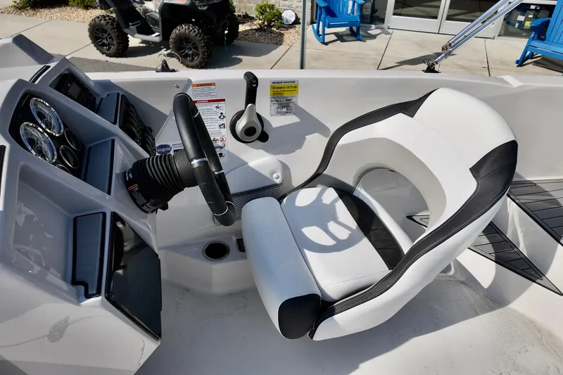 Slide: The Image of 2026 Starcraft SVX 211 OB boat cockpit with steering wheel and modern controls. - 10