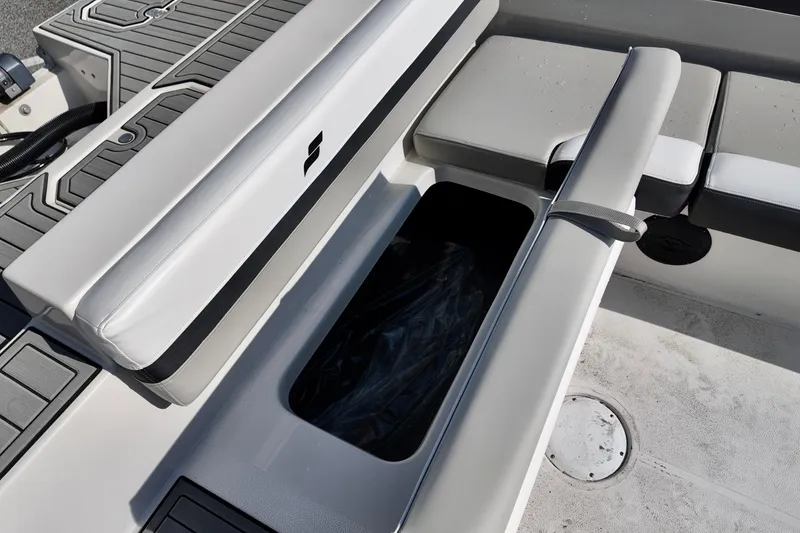 Slide: The Image of 2026 Starcraft SVX 211 OB boat interior with open storage compartment and cushioned seating. - 14