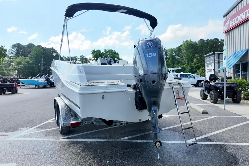 Slide: The Image of 2026 Starcraft SVX 211 OB boat with Yamaha 150 outboard motor in parking lot. - 3