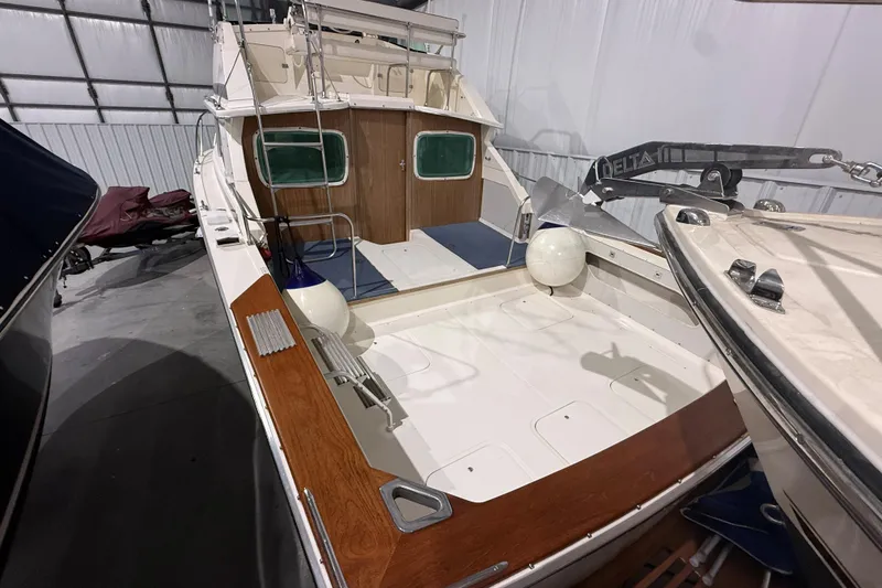 Slide: The Image of 1973 Bertram 28 Flybridge Cruiser in storage, showcasing spacious deck and classic design. - 2