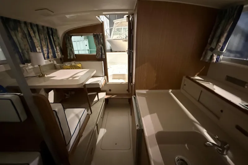 Slide: The Image of Interior of a 1973 Bertram 28 Flybridge Cruiser with dining area and kitchenette. - 12