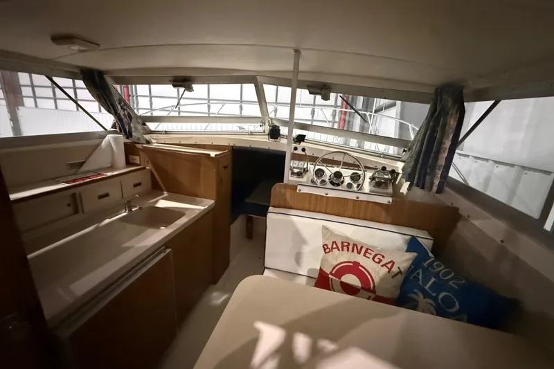 Slide: The Image of Interior of a 1973 Bertram 28 Flybridge Cruiser with helm and seating area. - 10