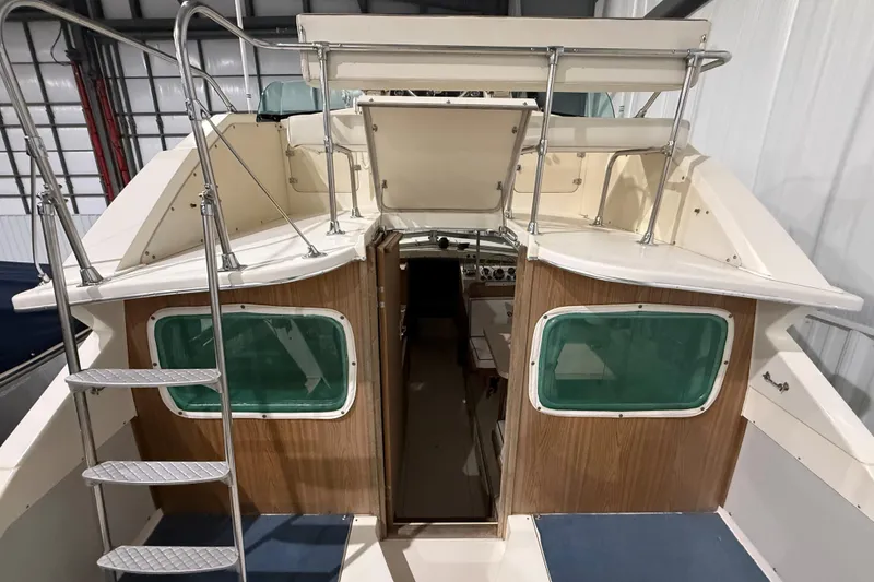 Slide: The Image of 1973 Bertram 28 Flybridge Cruiser interior view with ladder and windows. - 8