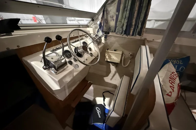 Slide: The Image of Interior of a 1973 Bertram 28 Flybridge Cruiser with vintage controls and seating. - 13