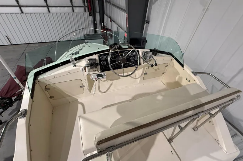 Slide: The Image of 1973 Bertram 28 Flybridge Cruiser helm with steering wheel and control panel. - 4