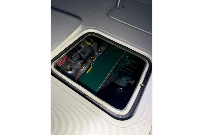 Slide: The Image of Engine compartment of a 1973 Bertram 28 Flybridge Cruiser, showcasing mechanical components. - 15