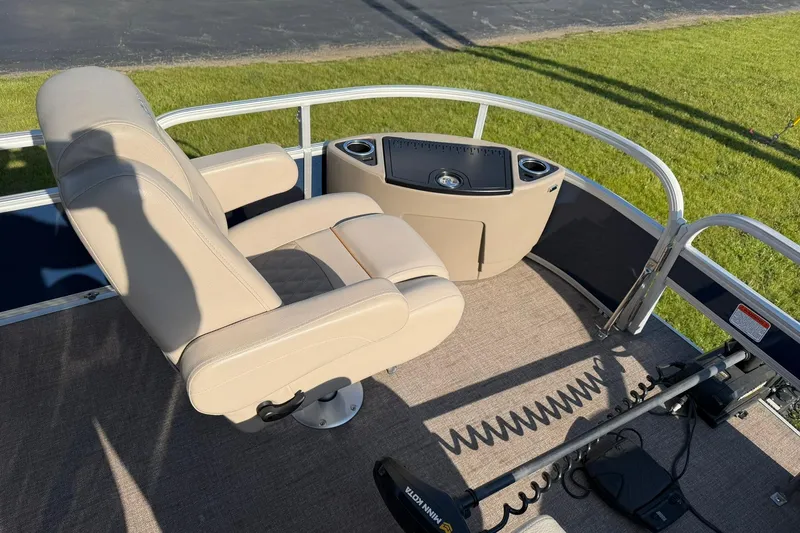 Slide: The Image of 2021 Ranger Reata 223F boat interior with beige captain's chair and control panel. - 10