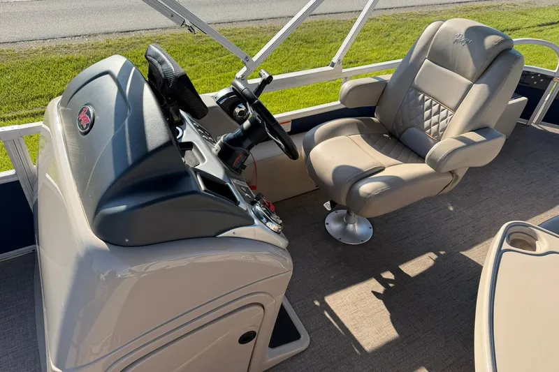 Slide: The Image of Captain's chair and helm of 2021 Ranger Reata 223F boat, featuring plush seating. - 12