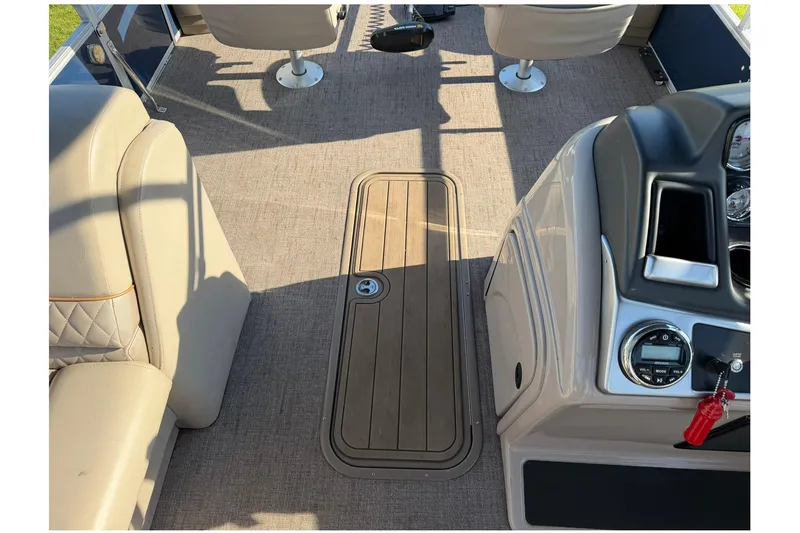 Slide: The Image of Interior of 2021 Ranger Reata 223F boat with beige seating and control panel. - 15