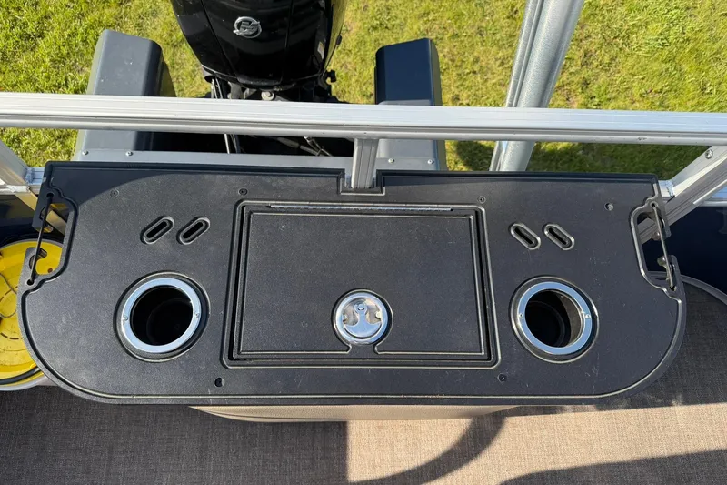 Slide: The Image of 2021 Ranger Reata 223F boat console with cup holders and storage compartment. - 20