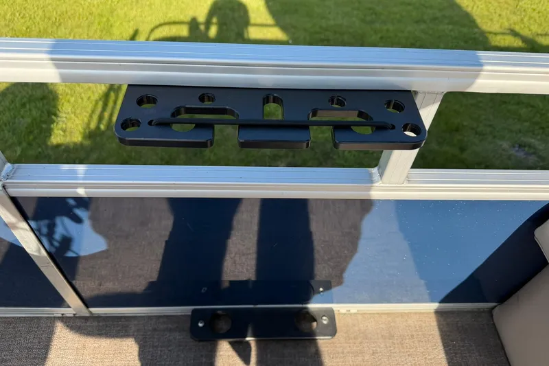 Slide: The Image of Mounting bracket on 2021 Ranger Reata 223F boat railing, with grass in the background. - 21