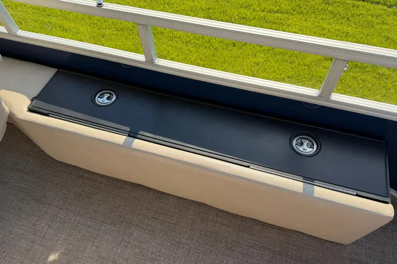 Slide: The Image of 2021 Ranger Reata 223F boat seat with storage compartment, featuring a sleek black lid. - 22