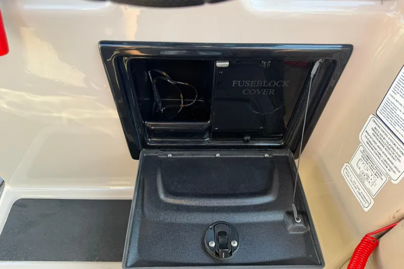 Slide: The Image of 2021 Ranger Reata 223F fuse block cover with open compartment and visible wiring. - 23