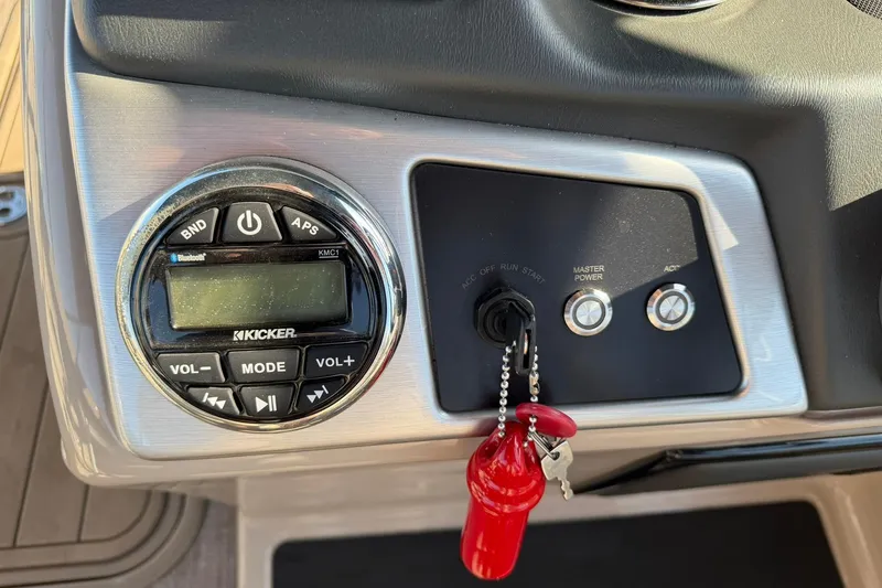 Slide: The Image of Control panel of 2021 Ranger Reata 223F boat with Kicker audio system and ignition keys. - 24