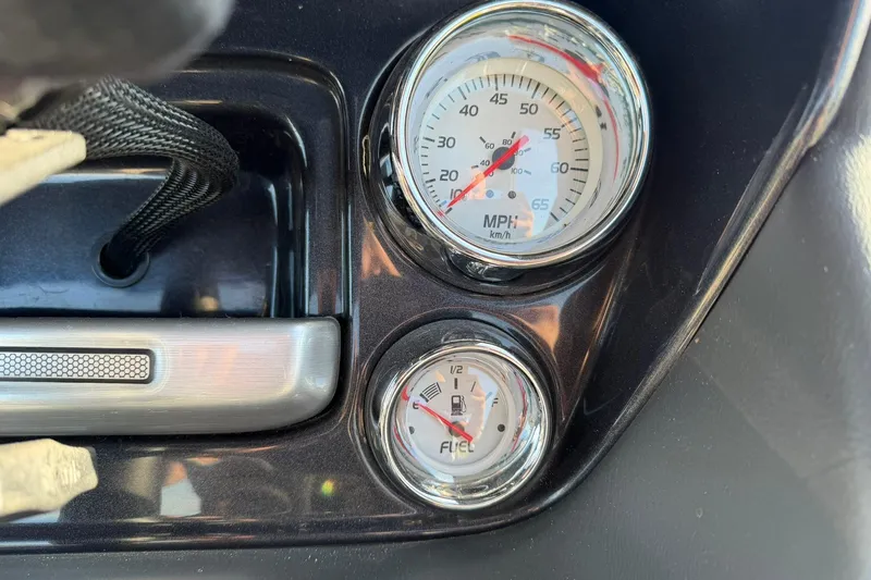 Slide: The Image of Dashboard gauges of a 2021 Ranger Reata 223F boat, showing speed and fuel levels. - 25