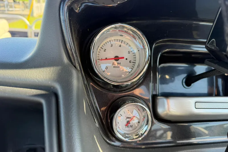 Slide: The Image of Dashboard gauges of 2021 Ranger Reata 223F boat, showing RPM and trim indicators. - 26