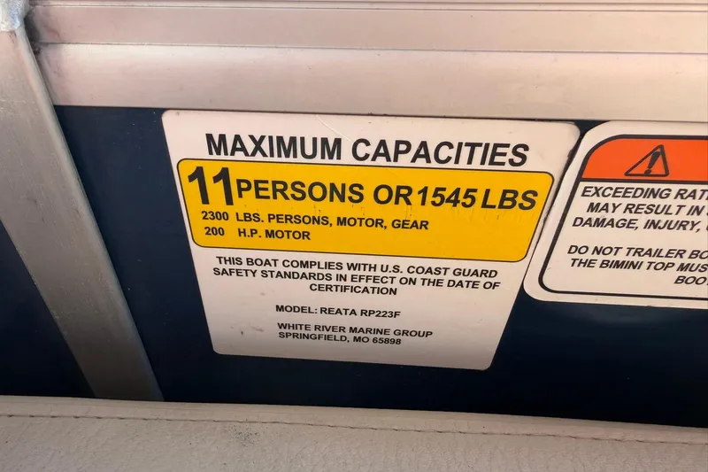 Slide: The Image of Maximum capacity label for 2021 Ranger Reata 223F boat, 11 persons or 1545 lbs. - 27