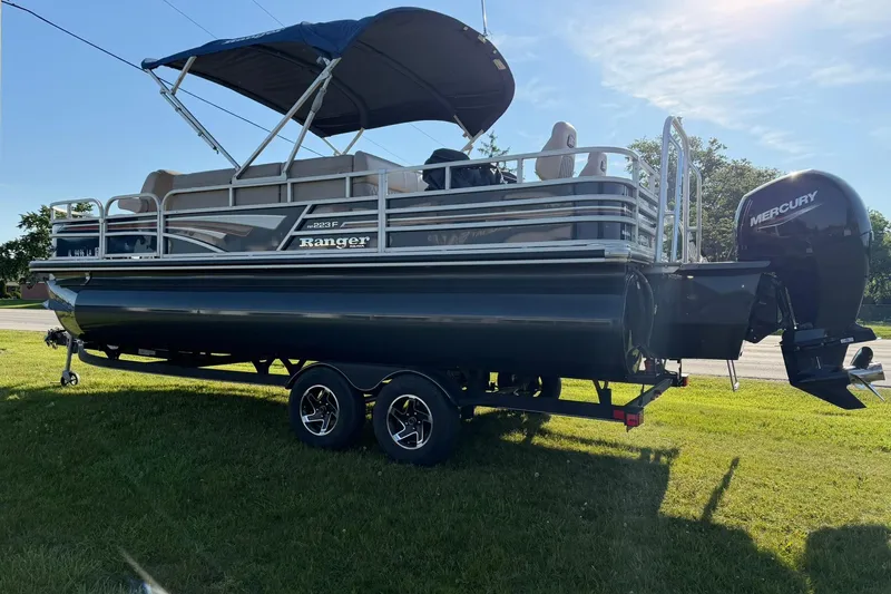 Slide: The Image of 2021 Ranger Reata 223F pontoon boat with Mercury engine on trailer. - 3